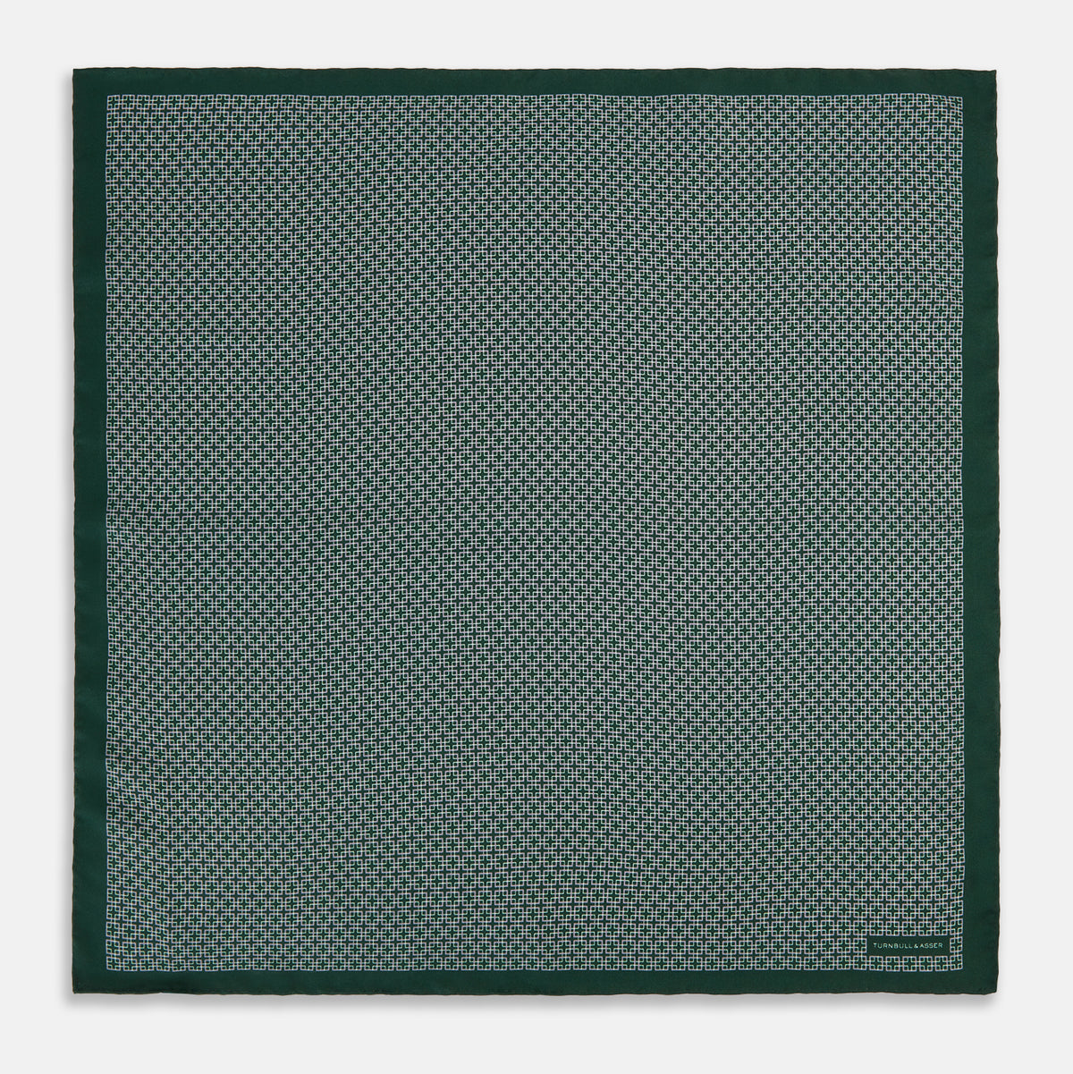 View 4 of product Turnbull & Asser UK Geometric Green Forest Green Pocket Square in Silk featuring a white geometric motif and a solid green border.