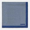 View 3 of product A blue pocket square from Turnbull & Asser UK, featuring a geometric white square pattern and a solid blue border. One corner is folded to highlight the striking design on both sides, with the brand name displayed on the bottom right. Product name: POCKET SQUARE SQUARE PATTERNED BANANA.