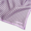 View 2 of product Crafted by Turnbull & Asser UK, the Geometric Lilac Pocket Square in Silk features an elegant square pattern in lilac hues, accented by a solid lavender border. When folded, it tastefully displays a glimpse of the sophisticated patterned underside.