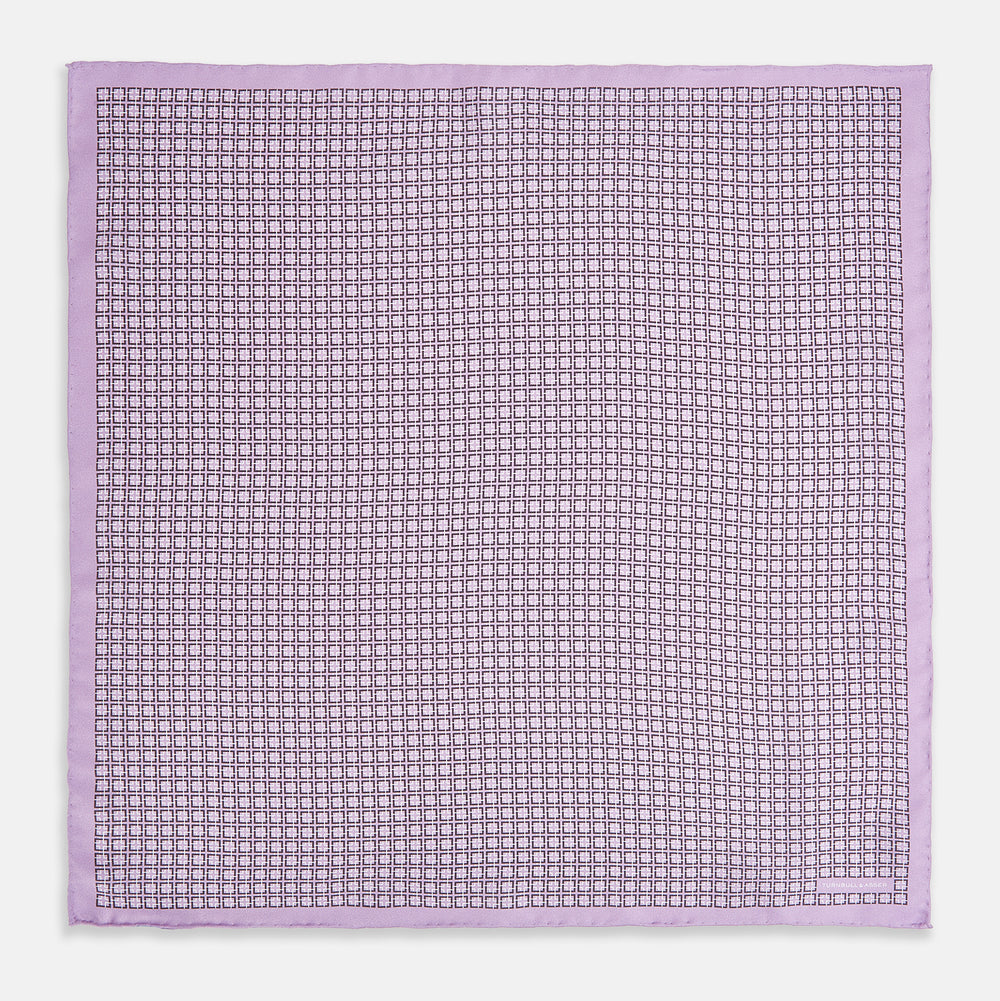Crafted by Turnbull & Asser UK, the Geometric Lilac Pocket Square in Silk features an elegant square pattern in lilac hues, accented by a solid lavender border. When folded, it tastefully displays a glimpse of the sophisticated patterned underside.