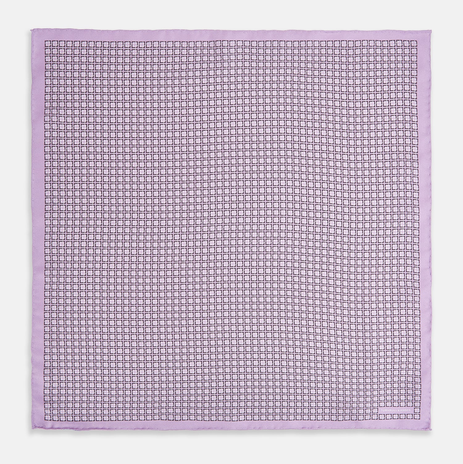 View 4 of product Crafted by Turnbull & Asser UK, the Geometric Lilac Pocket Square in Silk features an elegant square pattern in lilac hues, accented by a solid lavender border. When folded, it tastefully displays a glimpse of the sophisticated patterned underside.