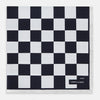 View 1 of product A square silk pocket square featuring a navy-on-white chequered pattern, labeled Turnbull & Asser UK with 2 of 20 in the bottom right corner—part of the limited edition Chequered Navy on White Frame Pocket Square from the Driver’s Capsule Collection.