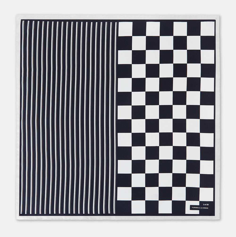 A square silk pocket square featuring a navy-on-white chequered pattern, labeled Turnbull & Asser UK with 2 of 20 in the bottom right corner—part of the limited edition Chequered Navy on White Frame Pocket Square from the Driver’s Capsule Collection.