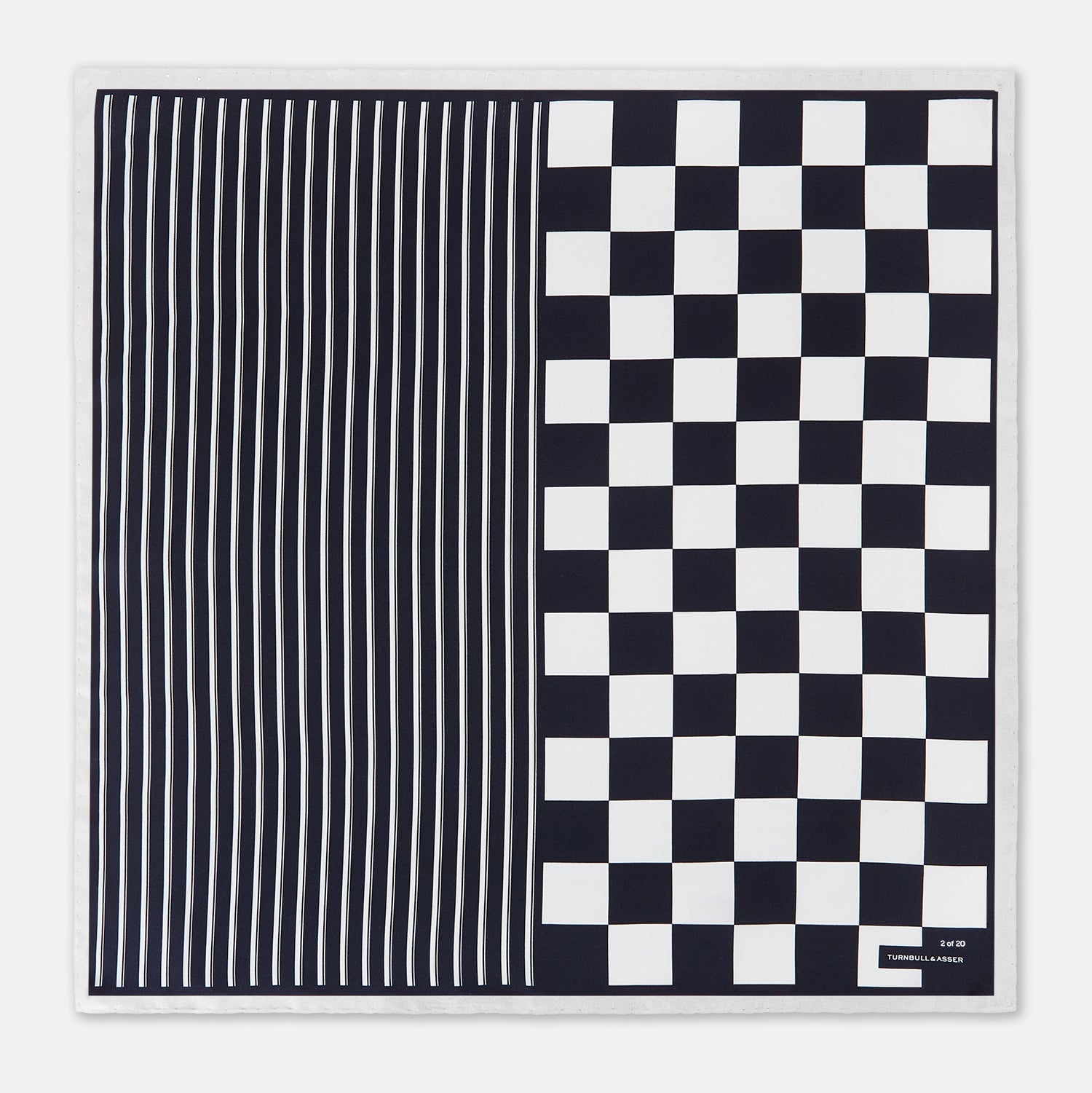 View 3 of product A square silk pocket square featuring a navy-on-white chequered pattern, labeled Turnbull & Asser UK with 2 of 20 in the bottom right corner—part of the limited edition Chequered Navy on White Frame Pocket Square from the Driver’s Capsule Collection.