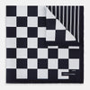 View 1 of product A chequered navy on navy frame silk pocket square from Turnbull & Asser UK, this piece is a limited edition from the Driver’s Capsule Collection, featuring “Turnbull & Asser” and “2 of 20” printed in one corner.