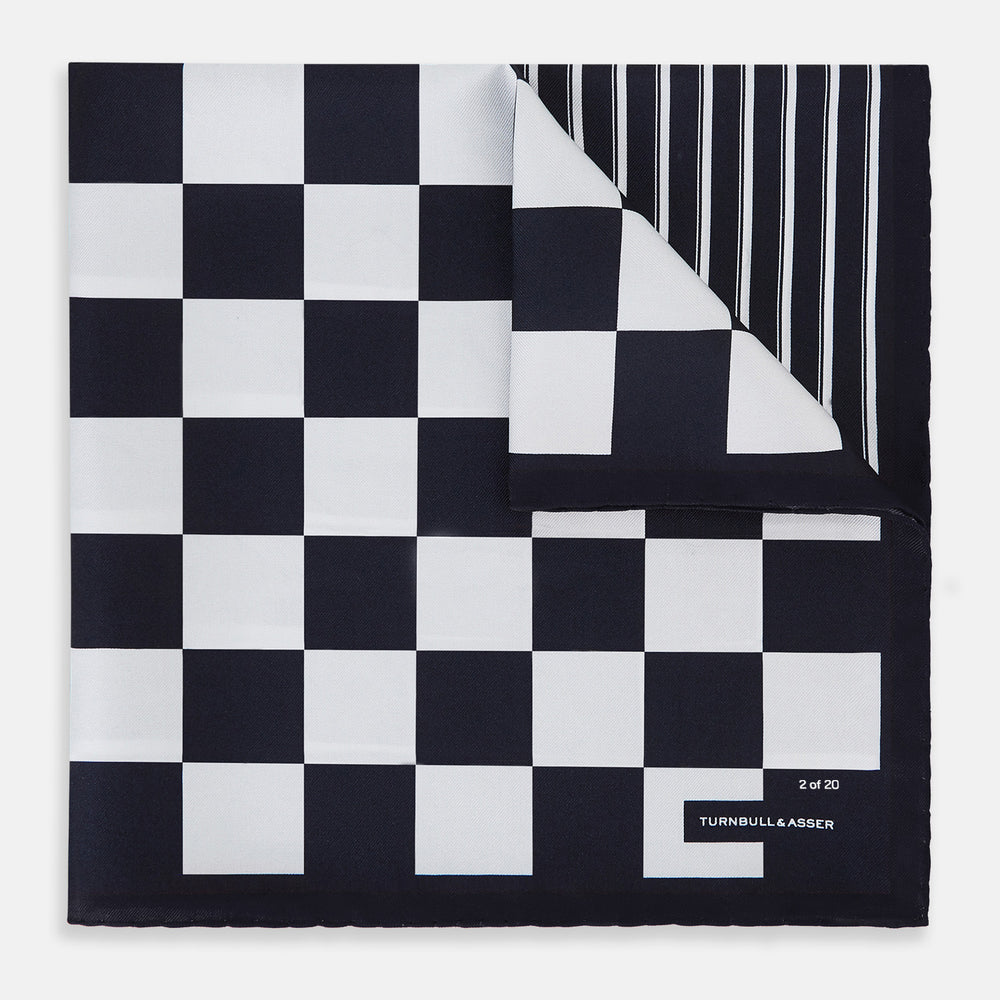 A chequered navy on navy frame silk pocket square from Turnbull & Asser UK, this piece is a limited edition from the Driver’s Capsule Collection, featuring “Turnbull & Asser” and “2 of 20” printed in one corner.