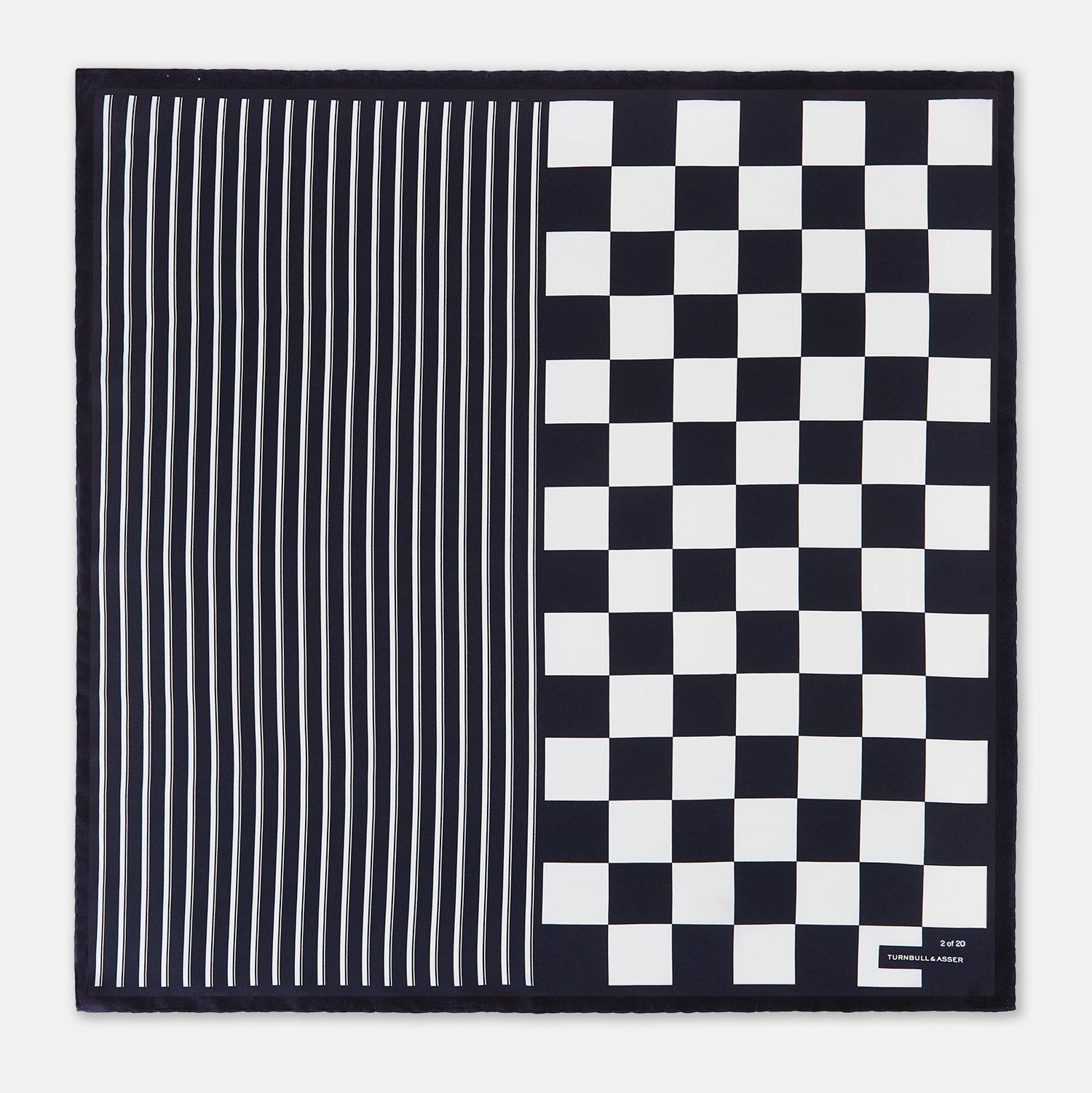 View 3 of product A chequered navy on navy frame silk pocket square from Turnbull & Asser UK, this piece is a limited edition from the Driver’s Capsule Collection, featuring “Turnbull & Asser” and “2 of 20” printed in one corner.