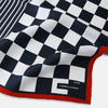 View 2 of product A limited edition silk pocket square from Turnbull & Asser UK, featuring a striking navy chequered pattern framed by a bold red border and finished with the text TURNBULL & ASSER in one corner. Part of the exclusive Driver’s Capsule Collection.
