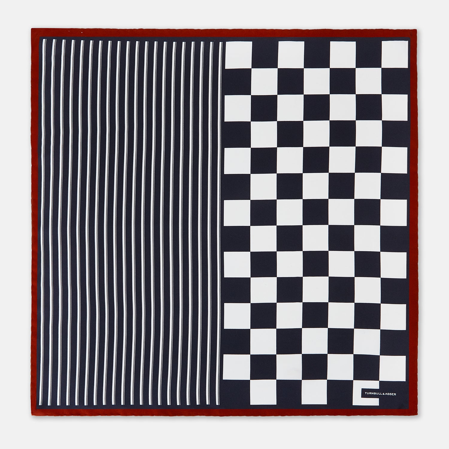 View 3 of product Introducing the Chequered Navy on Red Frame Pocket Square in Silk from Turnbull & Asser UK. This limited edition accessory, part of the Driver’s Capsule Collection, features a bold navy and white checkerboard pattern bordered by deep red silk. The bottom right corner is subtly detailed with white text reading “Turnbull & Asser” and “2 of 20.”.