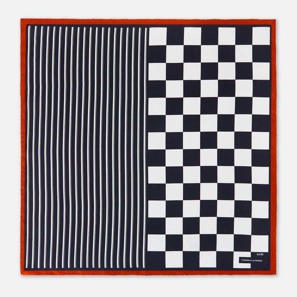 A limited edition silk pocket square from Turnbull & Asser UK, featuring a striking navy chequered pattern framed by a bold red border and finished with the text TURNBULL & ASSER in one corner. Part of the exclusive Driver’s Capsule Collection.