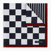 View 4 of product Introducing the Chequered Navy on Red Frame Pocket Square in Silk from Turnbull & Asser UK. This limited edition accessory, part of the Driver’s Capsule Collection, features a bold navy and white checkerboard pattern bordered by deep red silk. The bottom right corner is subtly detailed with white text reading “Turnbull & Asser” and “2 of 20.”.