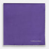 View 3 of product The Turnbull & Asser Violet and Ecru Piped Silk Pocket Square features a stitched edge and white brand logo, making it an elegant addition to formalwear.