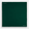View 4 of product The FOREST GREEN AND ECRU PIPED SILK POCKET SQUARE by Turnbull & Asser features forest green silk with ecru piping, neatly folded to display both sides, and the brand name printed in white in the lower right corner—ideal for formal attire.