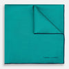 View 1 of product The Turquoise Piped Silk Pocket Square by Turnbull & Asser features dark blue edging and the brand’s logo, offering a sophisticated accent to formal outfits.