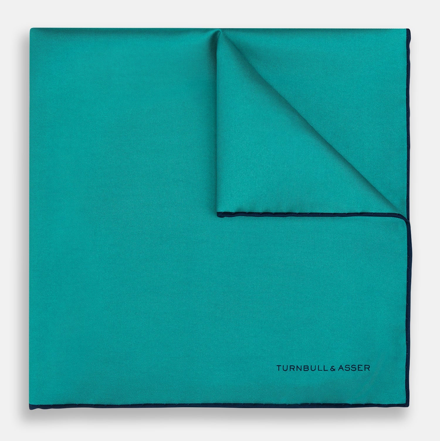 View 1 of product The Turquoise Piped Silk Pocket Square by Turnbull & Asser features dark blue edging and the brand’s logo, offering a sophisticated accent to formal outfits.