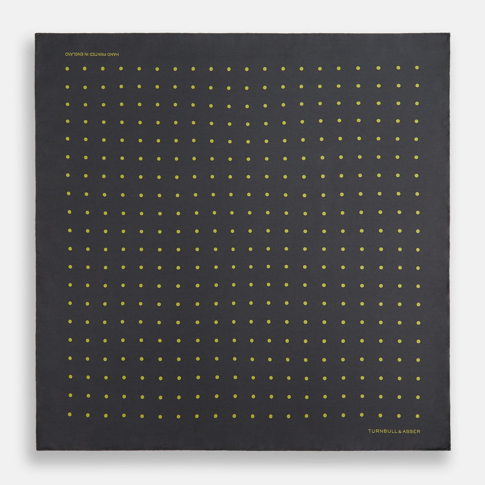 A grey and lime spot silk pocket square by Turnbull & Asser, featuring evenly spaced dots and the brand's logo in one corner—perfect for adding a stylish touch to formal attire.