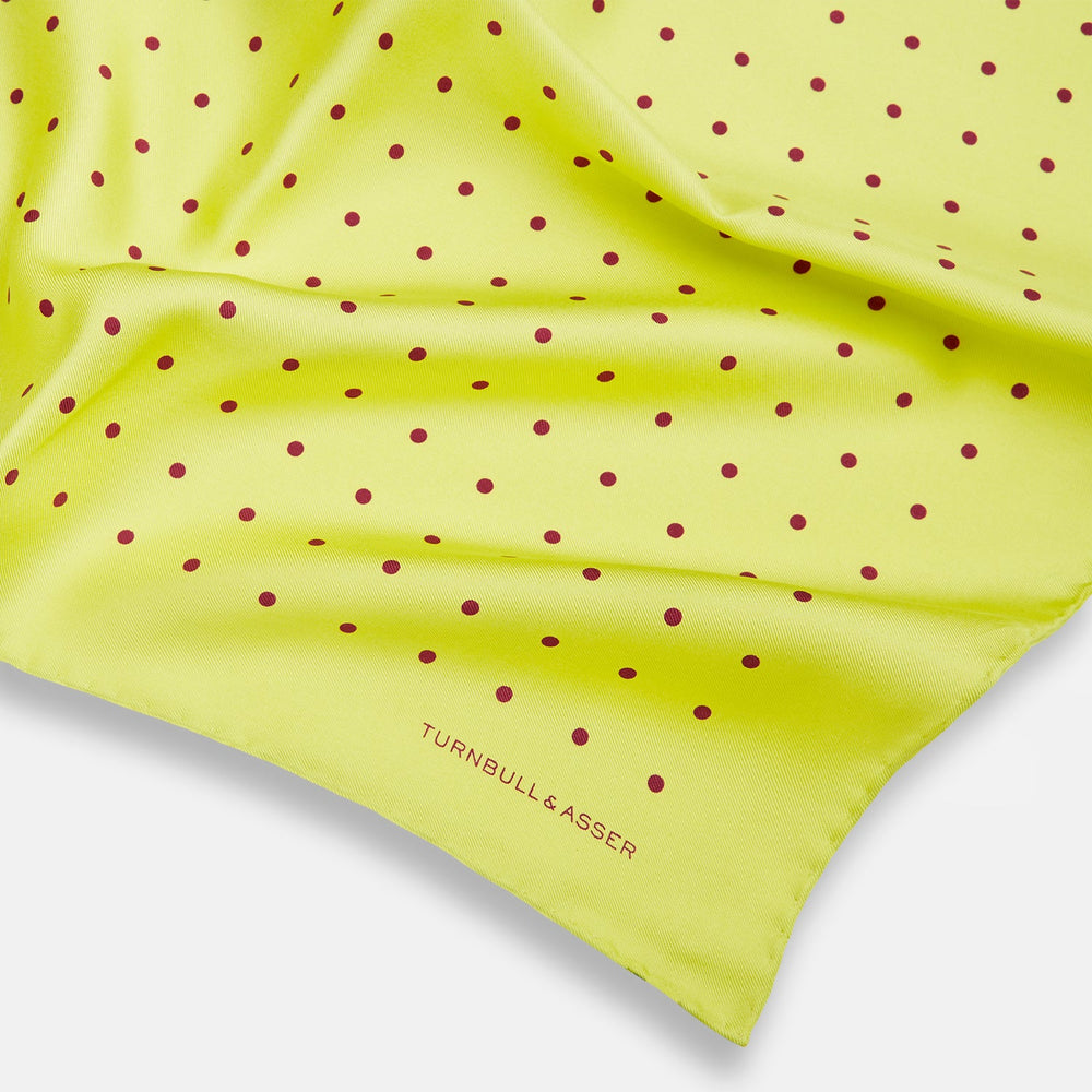 The Turnbull & Asser Chartreuse and Mauve Spot Silk Pocket Square features evenly spaced mauve dots and a branded corner—an ideal accessory to enhance your formal look.