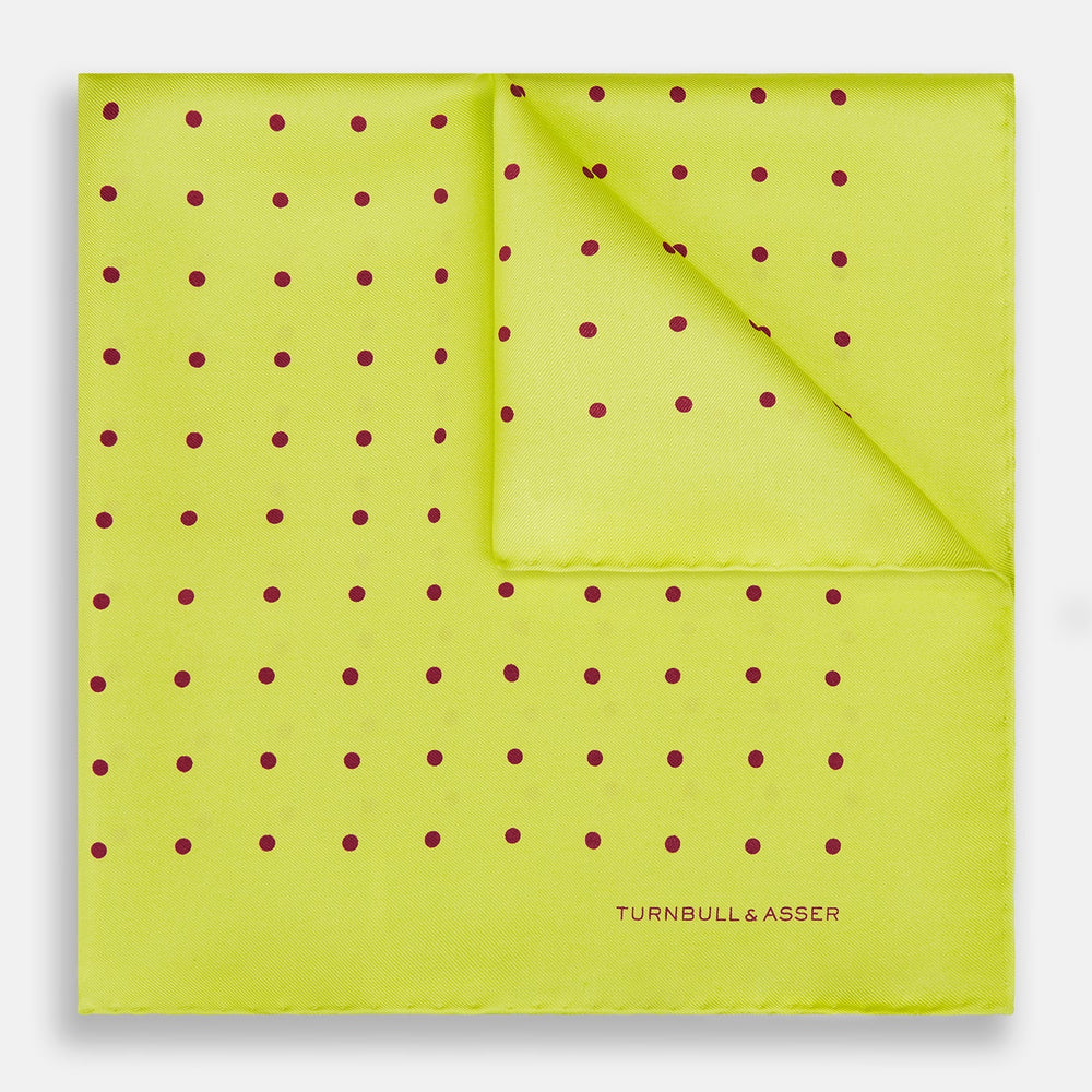 The Turnbull & Asser Chartreuse and Mauve Spot Silk Pocket Square features evenly spaced mauve dots and a branded corner—an ideal accessory to enhance your formal look.