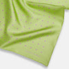 View 2 of product The Turnbull & Asser Melon Green and Lilac Spot Silk Pocket Square features evenly spaced lilac dots and the brand's name in one corner—a refined accessory for formal attire.