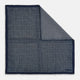 The Rosette Navy Pocket Square in Silk by Turnbull & Asser UK is a square, navy blue accessory featuring a small geometric pattern. Shown laid flat with one corner folded, it reveals a contrasting, finer motif on the reverse side. This elegant double-sided design offers versatile styling options for any occasion.
