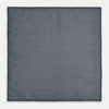 View 5 of product The Rosette Navy Pocket Square in Silk by Turnbull & Asser UK is a square, navy blue accessory featuring a small geometric pattern. Shown laid flat with one corner folded, it reveals a contrasting, finer motif on the reverse side. This elegant double-sided design offers versatile styling options for any occasion.