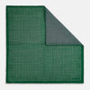 View 1 of product The Rosette Green Pocket Square in Silk by Turnbull & Asser UK features a small geometric medallion pattern and is shown folded to display a contrasting fine black-and-white design on the reverse side.