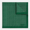 View 2 of product The Rosette Green Pocket Square in Silk by Turnbull & Asser UK features a small geometric medallion pattern and is shown folded to display a contrasting fine black-and-white design on the reverse side.