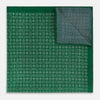 View 4 of product The Rosette Green Pocket Square in Silk by Turnbull & Asser UK features a small geometric medallion pattern and is shown folded to display a contrasting fine black-and-white design on the reverse side.