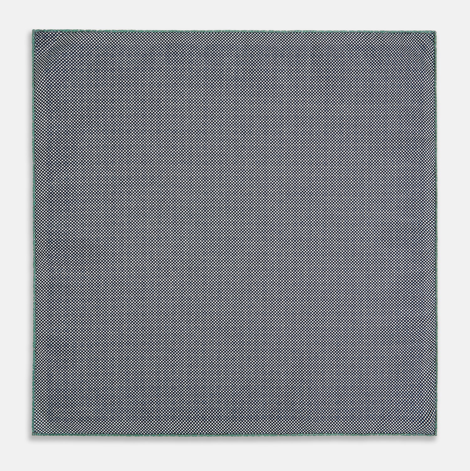 View 6 of product A square silk pocket square in Rosette Green by Turnbull & Asser UK, featuring a teal base with a grid of dark dots. One corner is folded to showcase the black and white microdot pattern on the reverse, while subtle hints of navy, aqua, and green form geometric medallions that lend a refined modern touch.