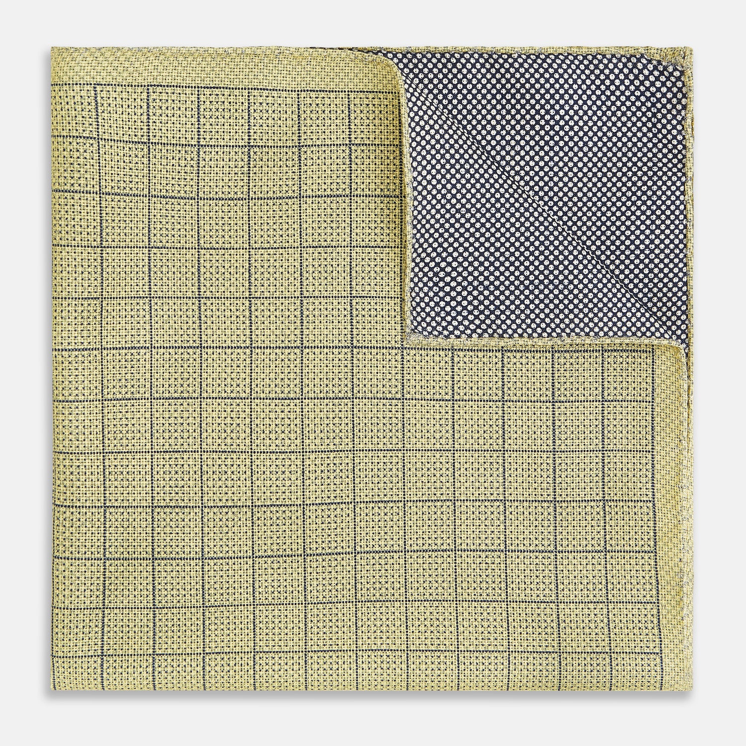View 3 of product A yellow silk pocket square featuring a small black grid pattern of dotted squares, neatly folded at one corner. "Turnbull & Asser UK" is printed in the bottom right corner.
