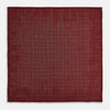 View 5 of product The Turnbull & Asser UK Checked Burgundy Pocket Square in Silk features a sophisticated burgundy hue with a subtle grid pattern. It's displayed folded at one corner to reveal a contrasting small checkered design on the reverse, showcasing its refined double-sided craftsmanship.