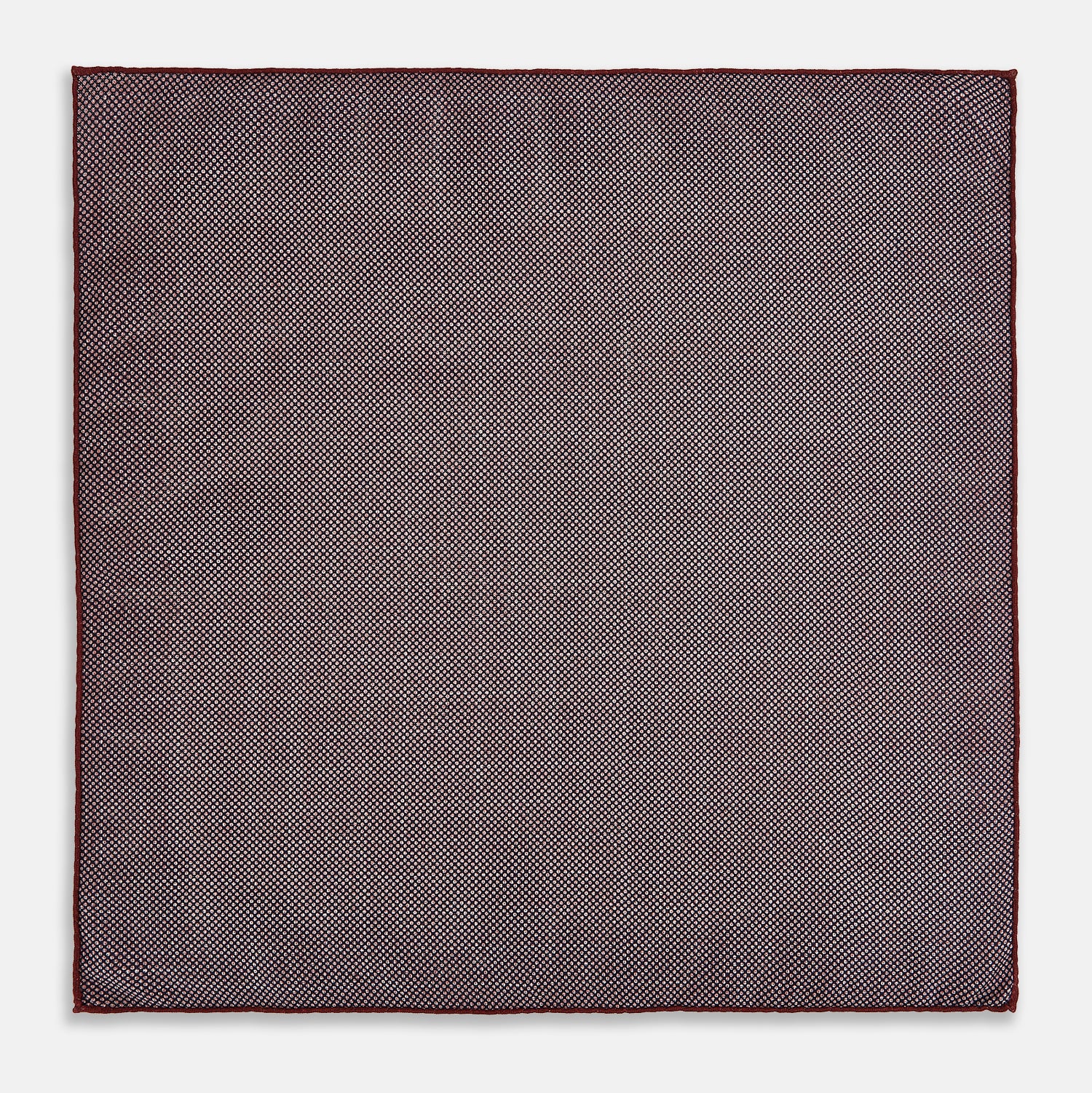 View 7 of product The Turnbull & Asser UK Checked Burgundy Pocket Square in Silk features a sophisticated burgundy hue with a subtle grid pattern. It's displayed folded at one corner to reveal a contrasting small checkered design on the reverse, showcasing its refined double-sided craftsmanship.