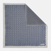 View 1 of product A square silk pocket square from Turnbull & Asser UK, featuring a subtle floral grey pattern; one corner is folded to reveal its double-sided design with a complementary pattern on the reverse side.