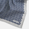 View 3 of product A square silk pocket square from Turnbull & Asser UK, featuring a subtle floral grey pattern; one corner is folded to reveal its double-sided design with a complementary pattern on the reverse side.