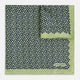 The Turnbull & Asser UK Floral Green Pocket Square in Silk is a square accessory featuring a blue floral pattern with a green border, partly folded at one corner to showcase its double-sided design, revealing a navy and light green dotted pattern on the reverse.