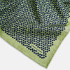 View 3 of product The Turnbull & Asser UK Floral Green Pocket Square in Silk is a square accessory featuring a blue floral pattern with a green border, partly folded at one corner to showcase its double-sided design, revealing a navy and light green dotted pattern on the reverse.
