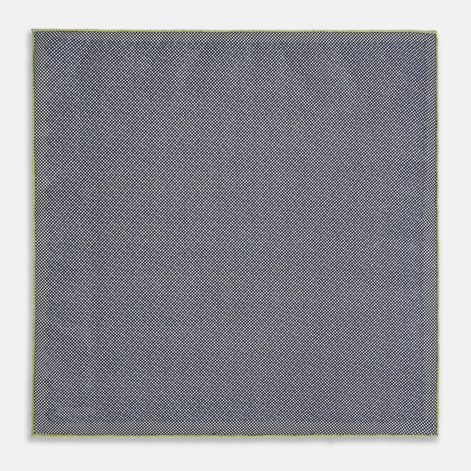 View 6 of product The Turnbull & Asser UK Floral Green Pocket Square in Silk is a square accessory featuring a blue floral pattern with a green border, partly folded at one corner to showcase its double-sided design, revealing a navy and light green dotted pattern on the reverse.