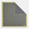 View 1 of product Introducing the Floral Yellow Pocket Square in Silk by Turnbull & Asser UK—a sophisticated square accessory featuring a vibrant yellow border and a black-and-white geometric dot pattern. One corner is tastefully folded to reveal its double-sided design, showcasing a smaller, denser dot motif on the reverse. Perfect for adding a modern touch of flair to any outfit or setting.