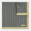 View 2 of product Introducing the Floral Yellow Pocket Square in Silk by Turnbull & Asser UK—a sophisticated square accessory featuring a vibrant yellow border and a black-and-white geometric dot pattern. One corner is tastefully folded to reveal its double-sided design, showcasing a smaller, denser dot motif on the reverse. Perfect for adding a modern touch of flair to any outfit or setting.