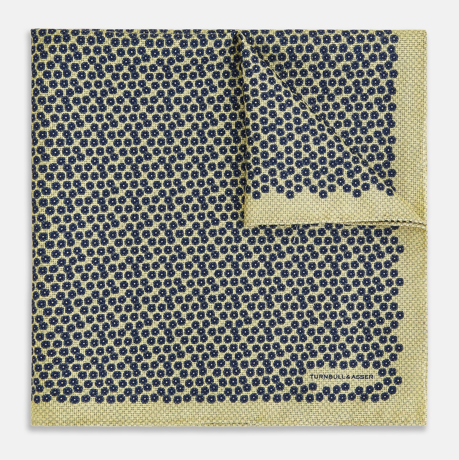 View 2 of product Introducing the Floral Yellow Pocket Square in Silk by Turnbull & Asser UK—a sophisticated square accessory featuring a vibrant yellow border and a black-and-white geometric dot pattern. One corner is tastefully folded to reveal its double-sided design, showcasing a smaller, denser dot motif on the reverse. Perfect for adding a modern touch of flair to any outfit or setting.