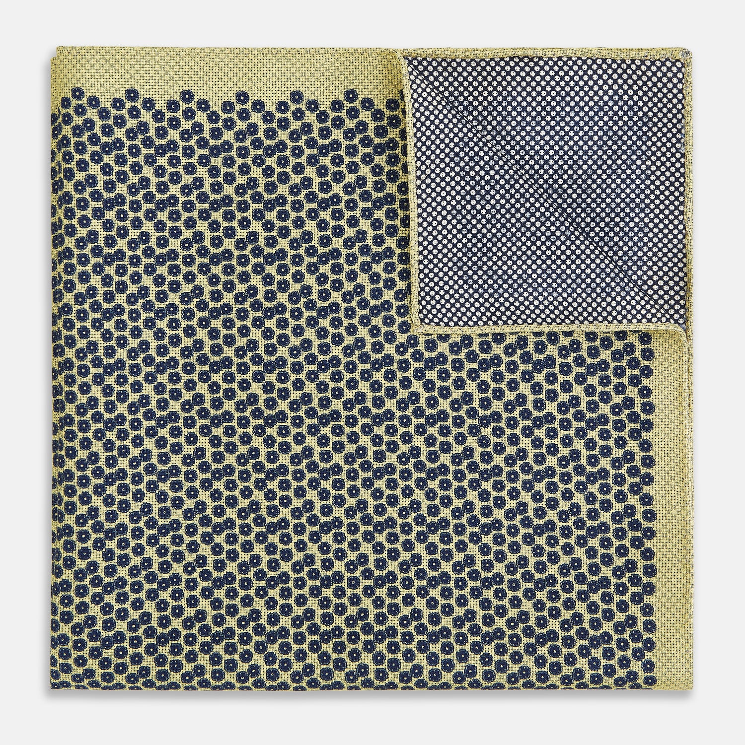View 4 of product Introducing the Floral Yellow Pocket Square in Silk by Turnbull & Asser UK—a sophisticated square accessory featuring a vibrant yellow border and a black-and-white geometric dot pattern. One corner is tastefully folded to reveal its double-sided design, showcasing a smaller, denser dot motif on the reverse. Perfect for adding a modern touch of flair to any outfit or setting.