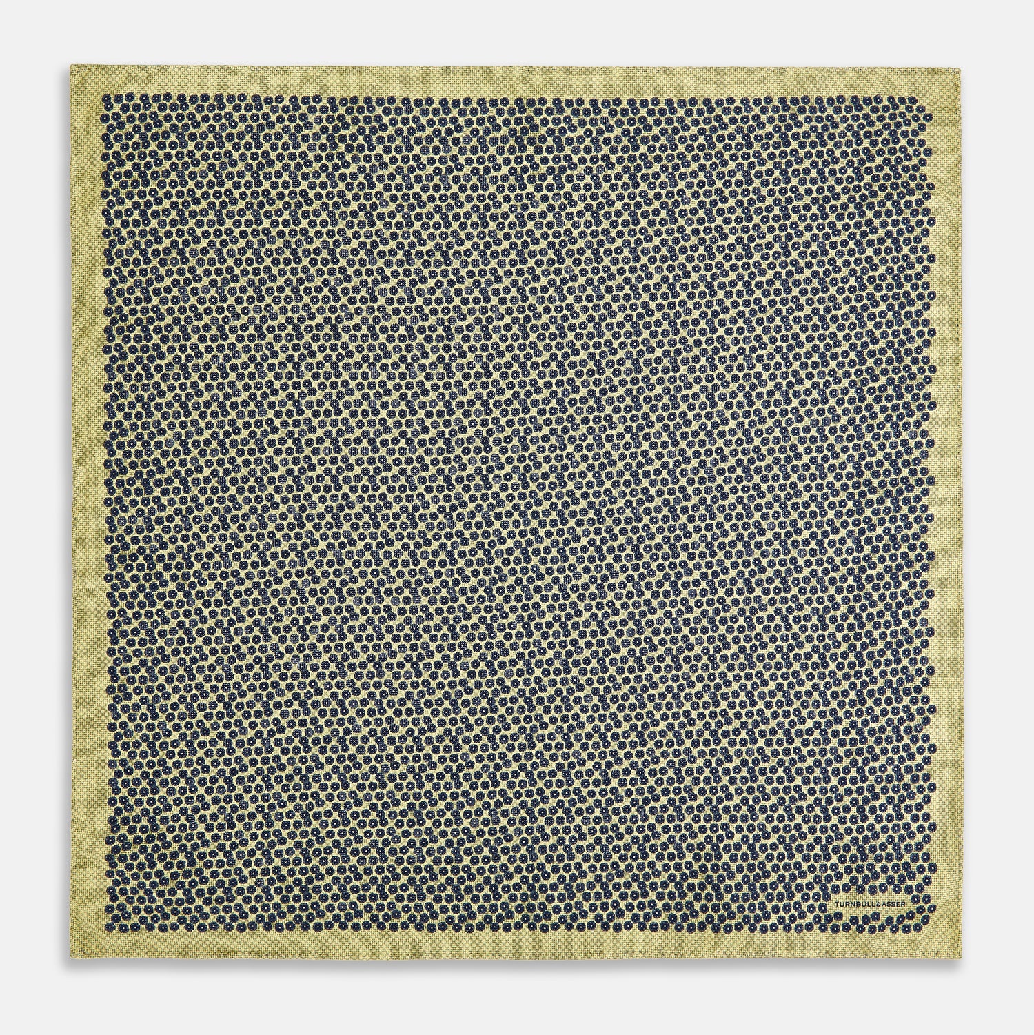 View 5 of product Introducing the Floral Yellow Pocket Square in Silk by Turnbull & Asser UK—a sophisticated square accessory featuring a vibrant yellow border and a black-and-white geometric dot pattern. One corner is tastefully folded to reveal its double-sided design, showcasing a smaller, denser dot motif on the reverse. Perfect for adding a modern touch of flair to any outfit or setting.
