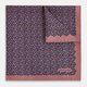 The Floral Pink Pocket Square in Silk by Turnbull & Asser UK showcases a refined pattern with a pink floral design and a contrasting border. The top right corner is elegantly folded to reveal the reverse side’s complementary blue and white dotted motif, emphasizing its double-sided versatility.