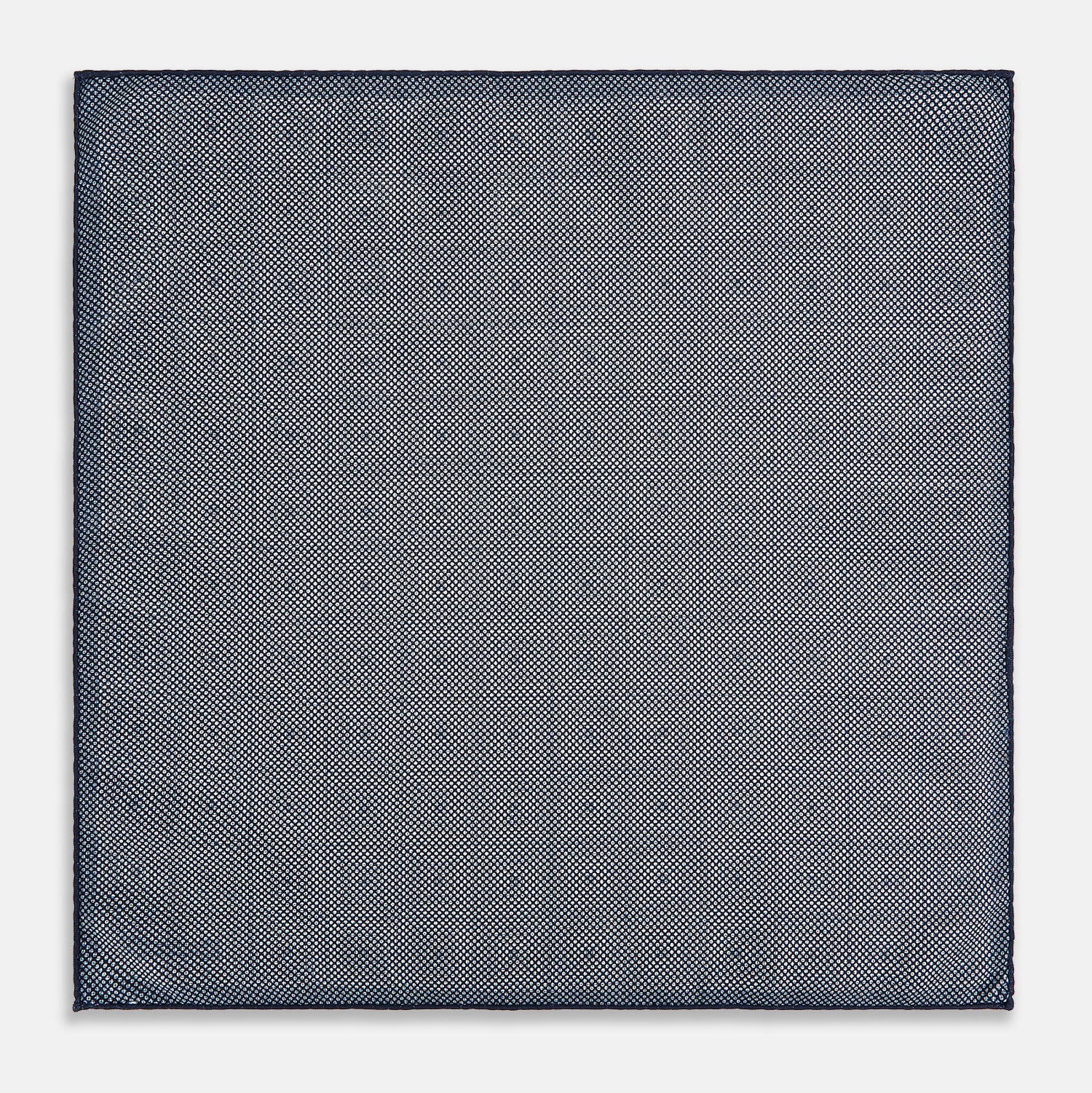 View 6 of product Introducing the Geometric Navy Tile Pocket Square in Silk by Turnbull & Asser UK—a folded navy and white accessory showcasing a double-sided design, with one side featuring concentric squares that form a striking geometric pattern and the other adorned with an elegant small dot motif.