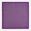 View 5 of product The Turnbull & Asser UK Geometric Purple Tile Pocket Square in Silk features a vibrant purple hue adorned with concentric square motifs. One corner is folded to reveal its double-sided design, showcasing a contrasting black-and-white dotted underside.