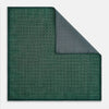 View 1 of product The Geometric Green Tile Pocket Square in Silk by Turnbull & Asser UK features a sophisticated tonal green design with a subtle pattern of concentric squares. One corner is folded to highlight the elegant double-sided construction, revealing a contrasting black and white small dot pattern on the reverse.