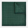 View 2 of product The Geometric Green Tile Pocket Square in Silk by Turnbull & Asser UK features a sophisticated tonal green design with a subtle pattern of concentric squares. One corner is folded to highlight the elegant double-sided construction, revealing a contrasting black and white small dot pattern on the reverse.