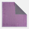 View 1 of product Certainly! Here’s a rewritten version of your sentence, incorporating the product data: The Geometric Lilac Tile Pocket Square in Silk by Turnbull & Asser UK features a lilac purple geometric pattern with a subtle square design, partially folded to reveal its double-sided construction with a contrasting black and white dotted pattern on the reverse.