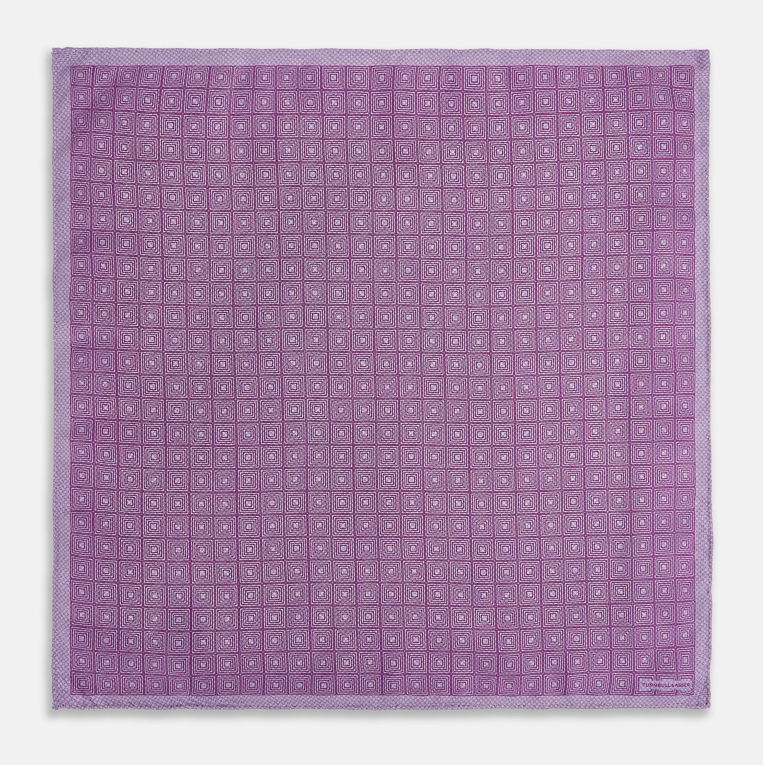 View 5 of product Certainly! Here’s a rewritten version of your sentence, incorporating the product data: The Geometric Lilac Tile Pocket Square in Silk by Turnbull & Asser UK features a lilac purple geometric pattern with a subtle square design, partially folded to reveal its double-sided construction with a contrasting black and white dotted pattern on the reverse.