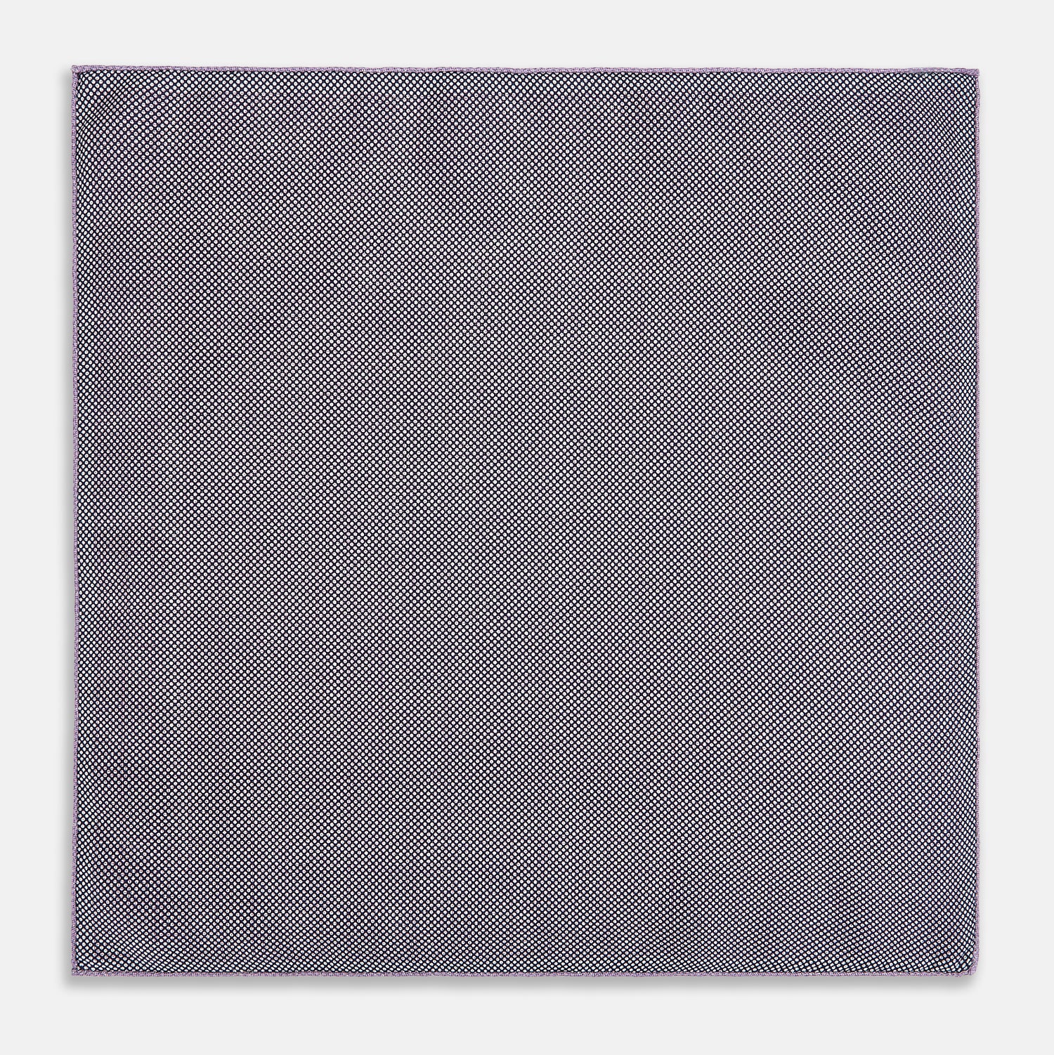 View 6 of product Certainly! Here’s a rewritten version of your sentence, incorporating the product data: The Geometric Lilac Tile Pocket Square in Silk by Turnbull & Asser UK features a lilac purple geometric pattern with a subtle square design, partially folded to reveal its double-sided construction with a contrasting black and white dotted pattern on the reverse.